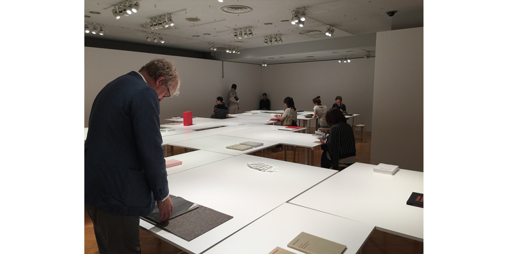Exhibition Tokyo Man leaning over books